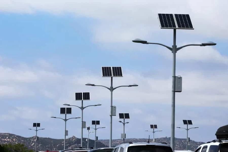 Technician adjusting solar panel tilt on pole