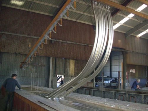 Lighting pole sections at a galvanizing bath
