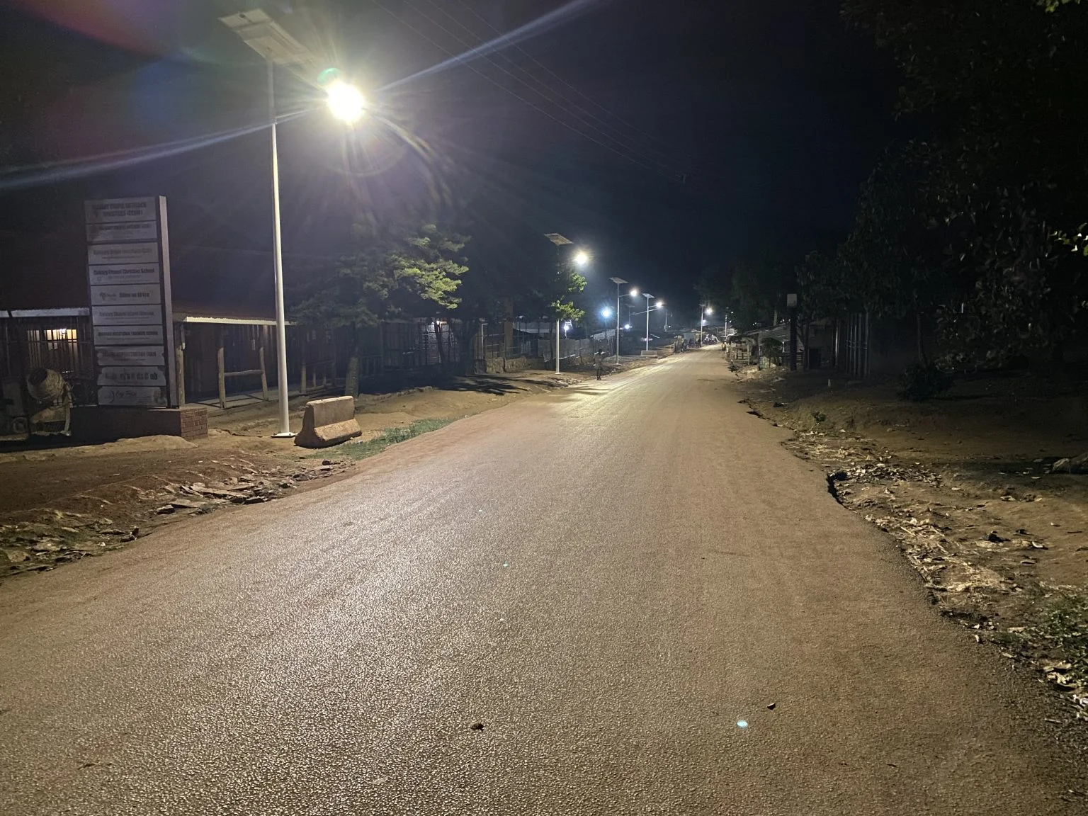 Solar street lights illuminating a road at night