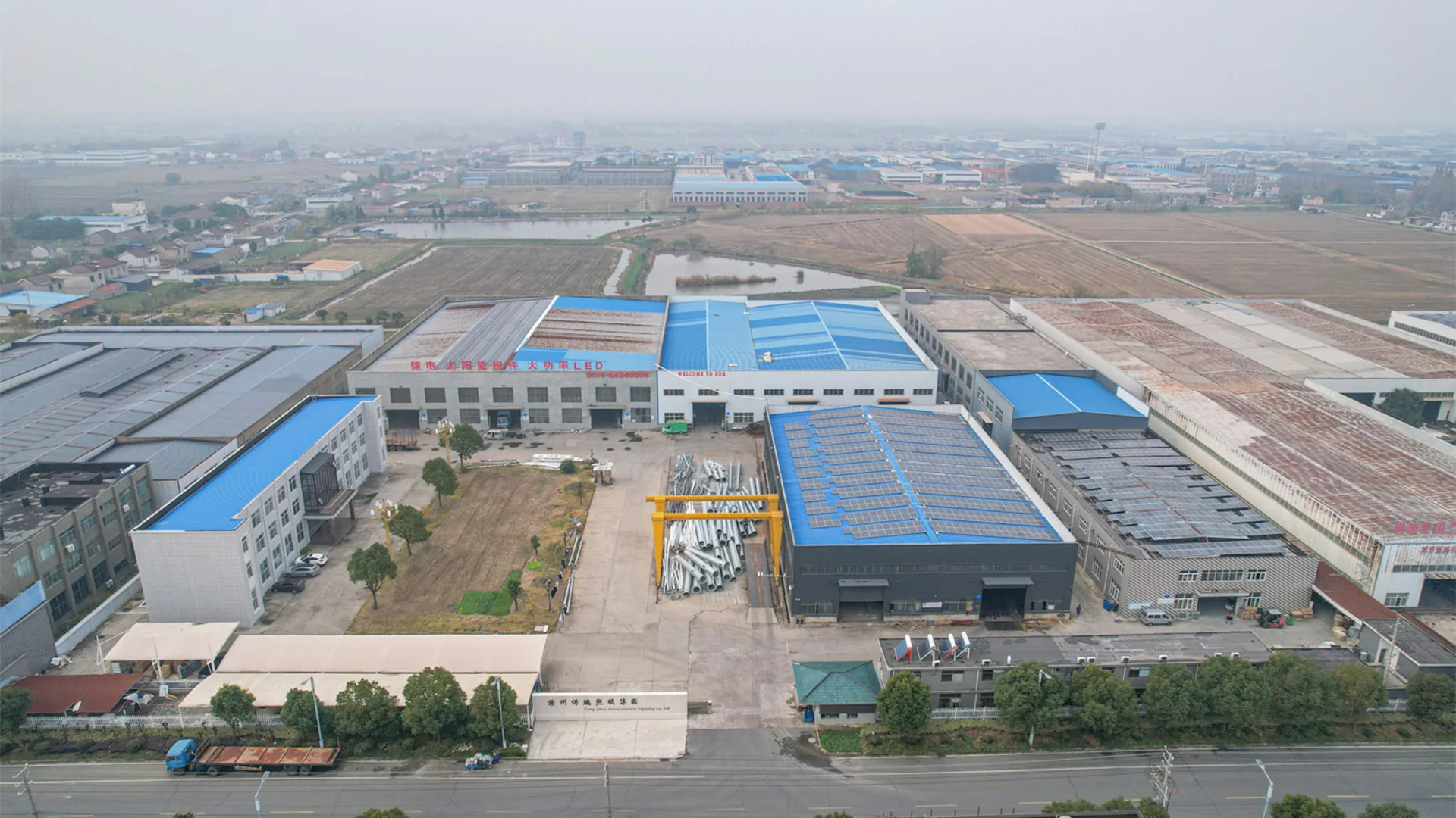Sunlurio factory aerial view with rooftop solar and outdoor lighting production workshops
