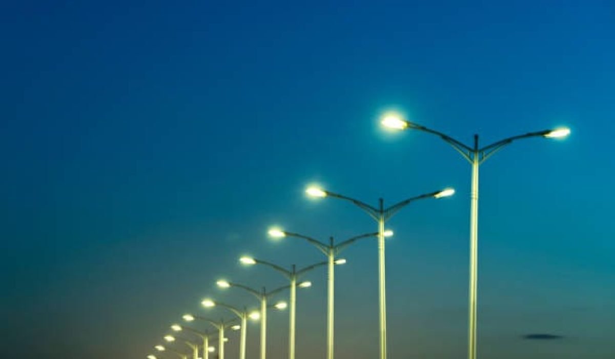 street lamps under blue sky at dusk